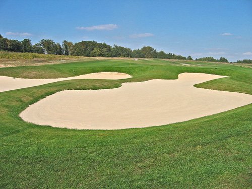 Budowa pola golfowego - obszerne i płytkie bunkry o stomych czołach amerykańskiego architekta pól golfowych.